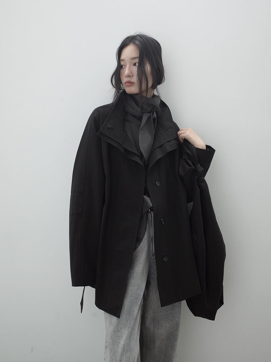 Person wearing a black Stand-up Collar Mid-Length Trench Coat over a gray outfit against a white background
