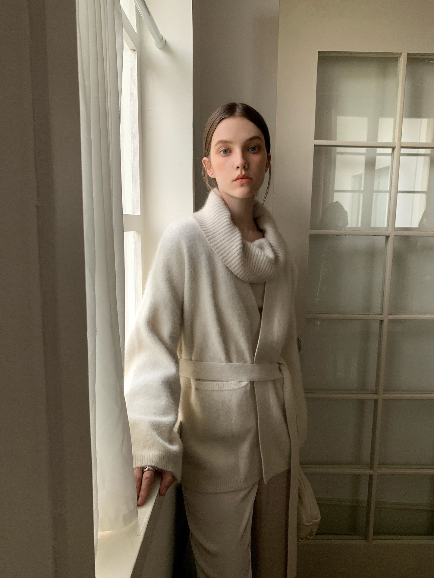 Woman wearing a Soft Fleece Mid-Thigh Long Cardigan Sweater Robe standing in a softly lit room.