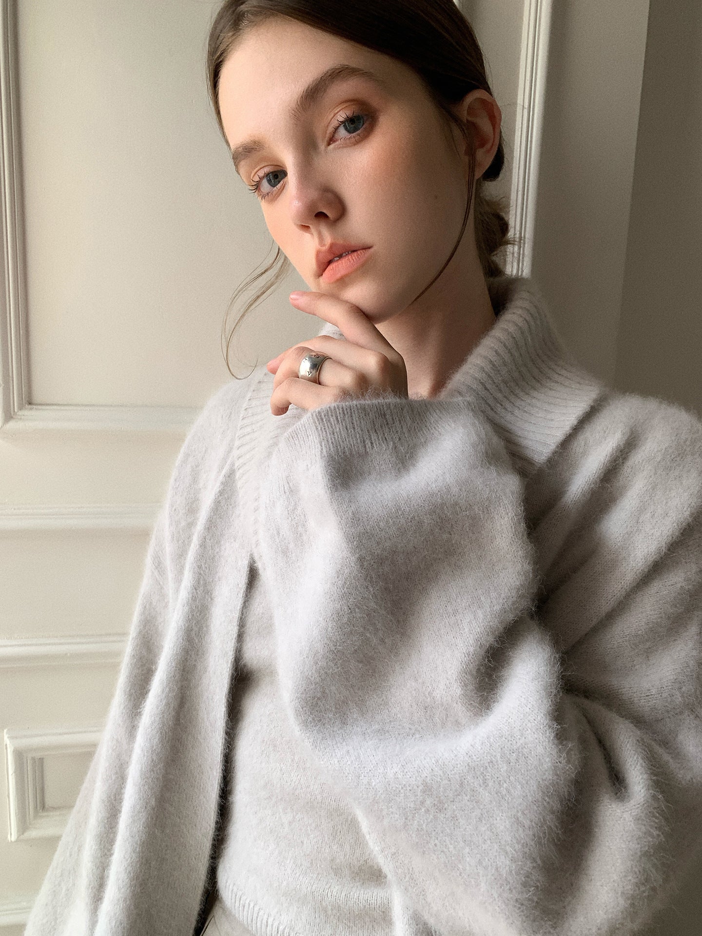 Woman wearing a light Soft Fleece Mid-Thigh Long Cardigan Sweater Robe indoors