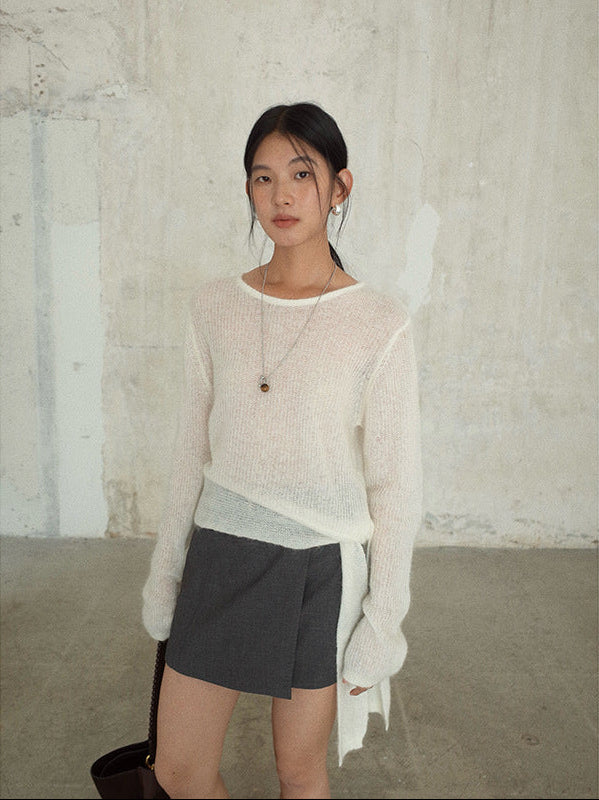 Woman wearing a light Strap Waist Long-sleeved Mohair Wool Knitted Sweater and dark skirt against a textured wall.