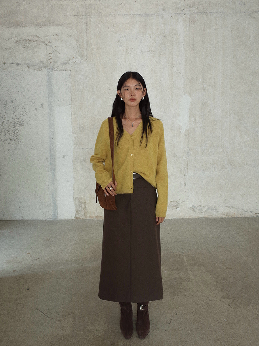 Woman wearing a yellow cardigan and brown Smooth High-waisted A-line Maxi Skirt against a plain wall.