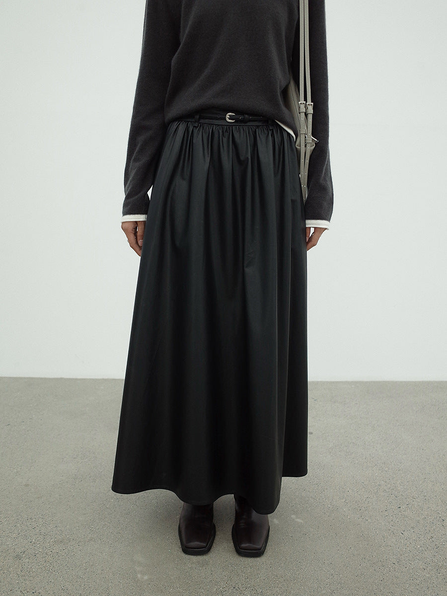 Woman wearing a Leather Drape Maxi A-Line Black Skirt with a plain background
