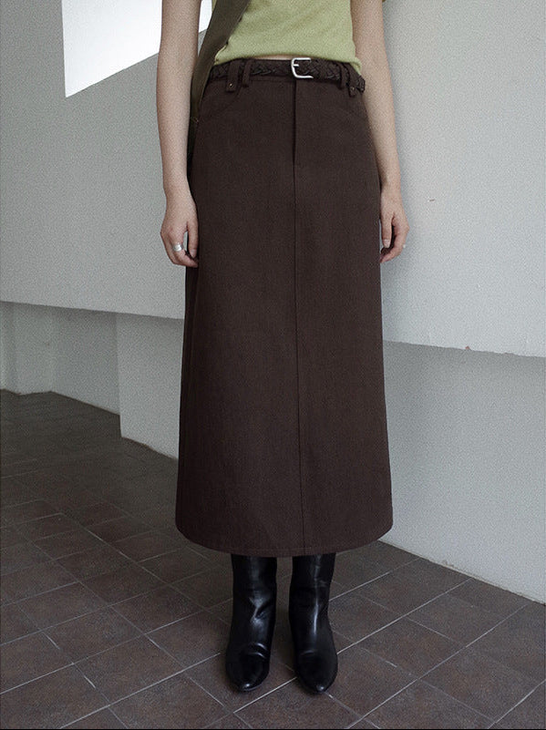 Woman wearing a brown High-waisted A-line Maxi Long Skirt with a belt in a minimal indoor setting