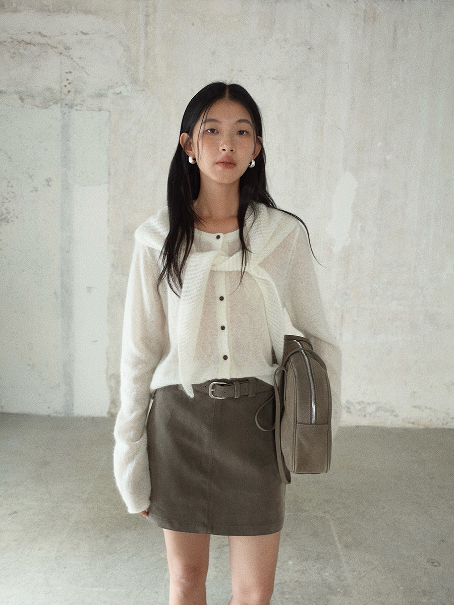 Woman wearing a white Long Sleeve Knitted Mohair Wool Cardigan Sweater with Scarf, brown skirt, and carrying a beige bag against a plain background