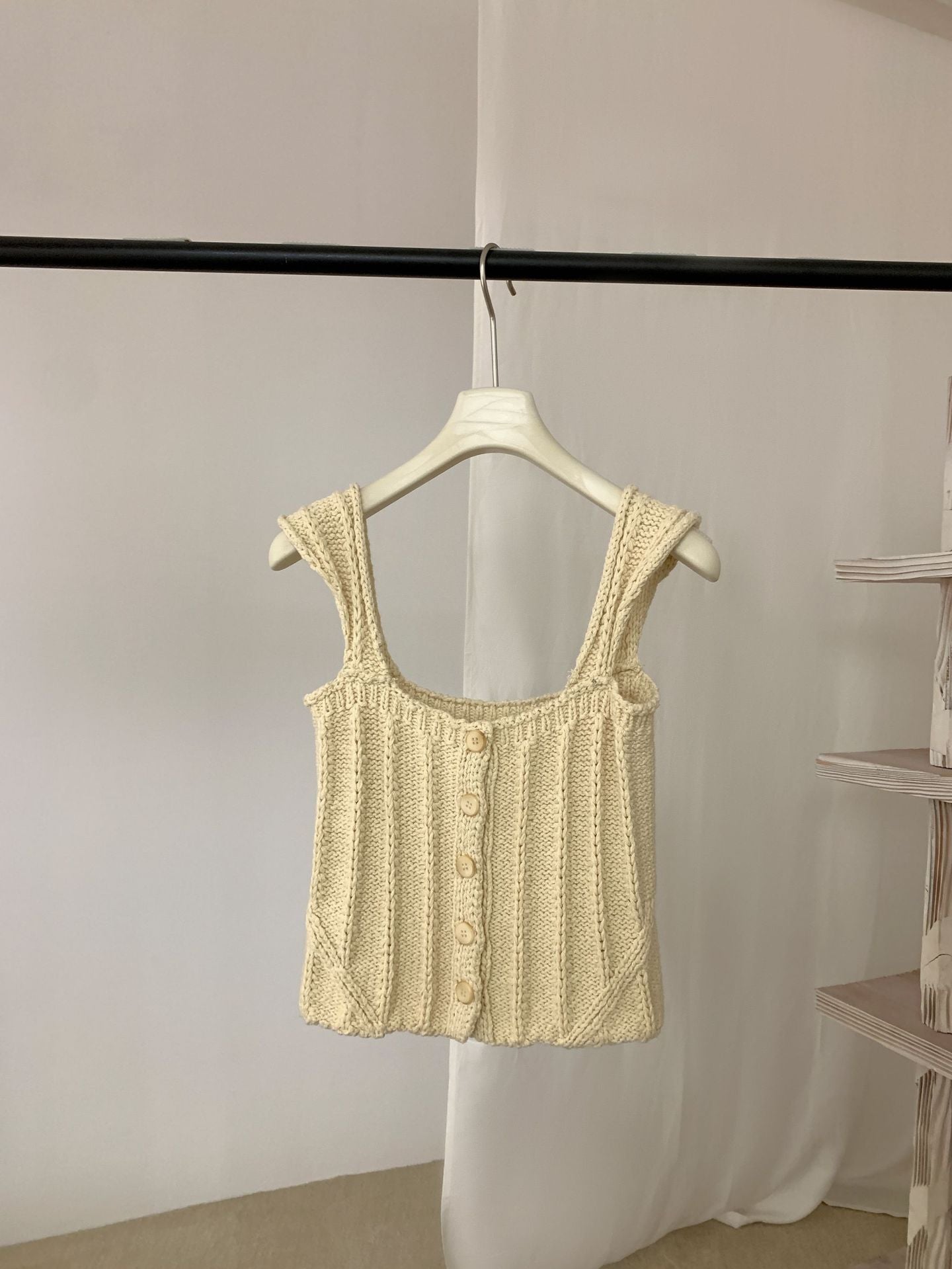 Light yellow Thick Thread Knitted Cardigan Sleeveless Vest Short Tank Top on a hanger against a plain background