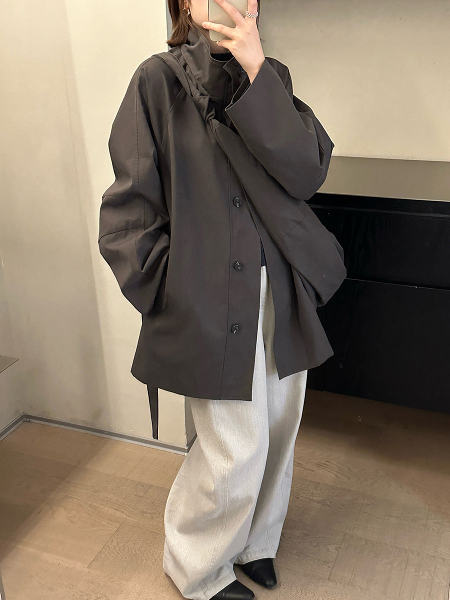 Person wearing a dark gray Stand-up Collar Mid-Length Trench Coat over a light-colored outfit indoors.