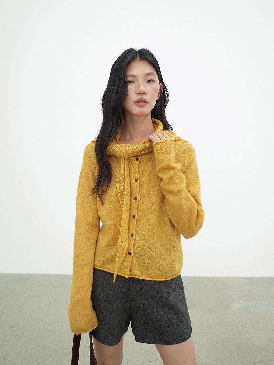 Woman wearing a mustard yellow Long Sleeve Knitted Mohair Wool Cardigan Sweater with Scarf and gray shorts on a white background
