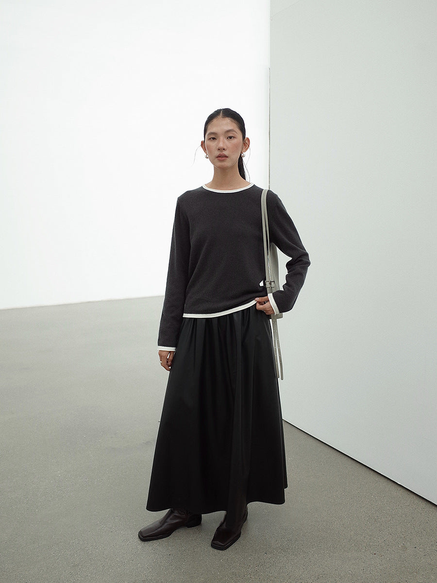 Woman wearing a Leather Drape Maxi A-Line Skirt outfit with a long skirt in a minimalistic setting
