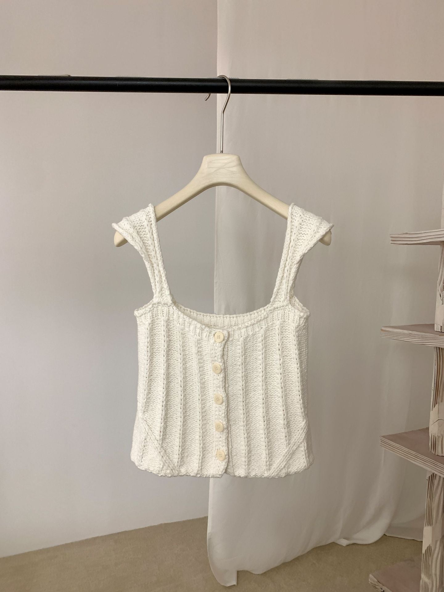 White Thick Thread Knitted Cardigan Sleeveless Vest Short Tank Top on a hanger against a plain background